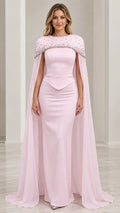 Front view of model wearing blush pink rhinestone capelet mermaid evening gown