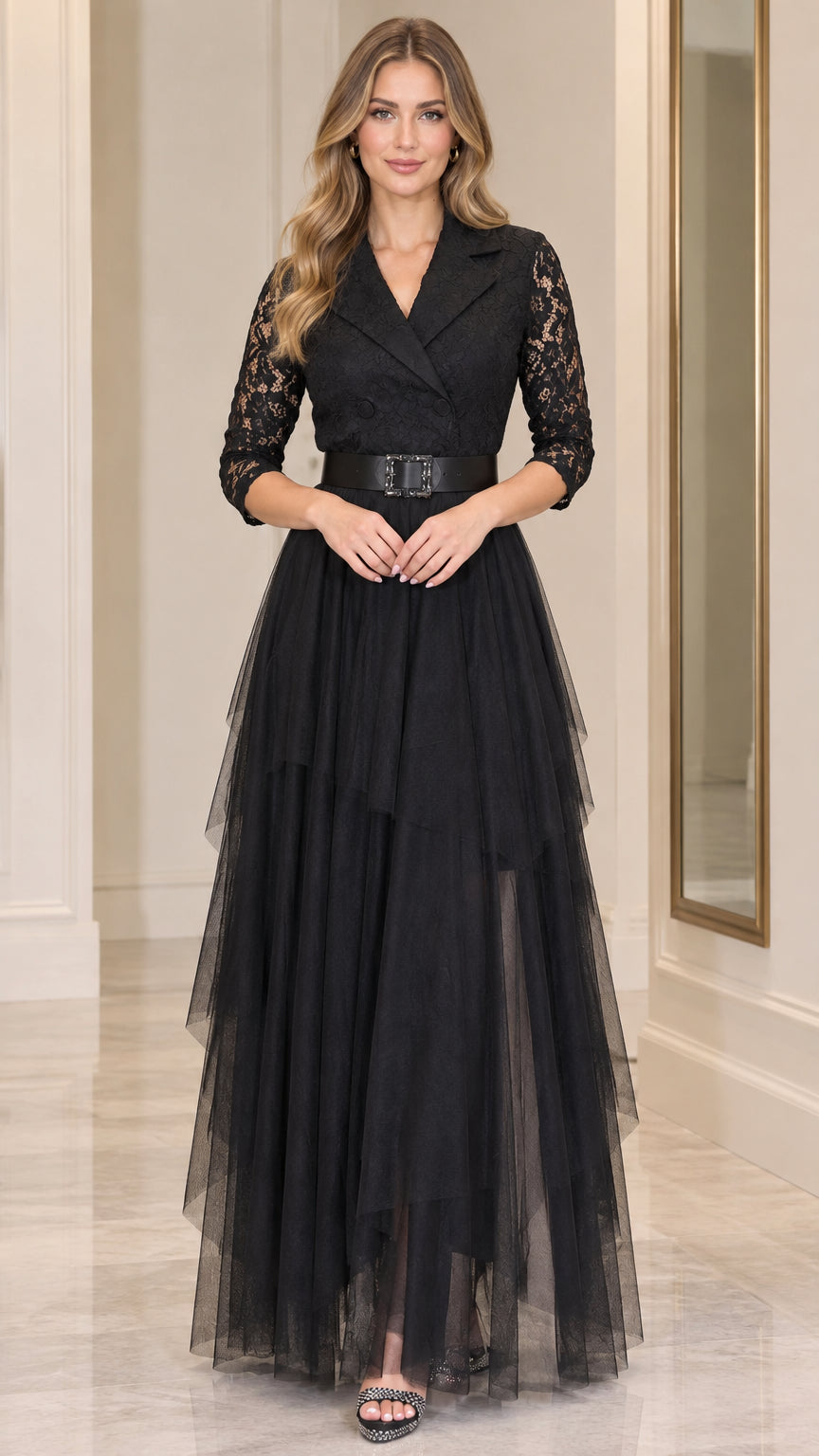Front full-length view of model wearing black tuxedo lapel lace tiered maxi evening dress