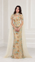 Front full view of Champagne floral embroidered evening gown with attached floor-length cape