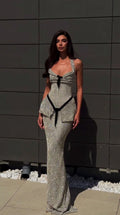 Model wearing silver glitter halter peplum maxi evening gown front view