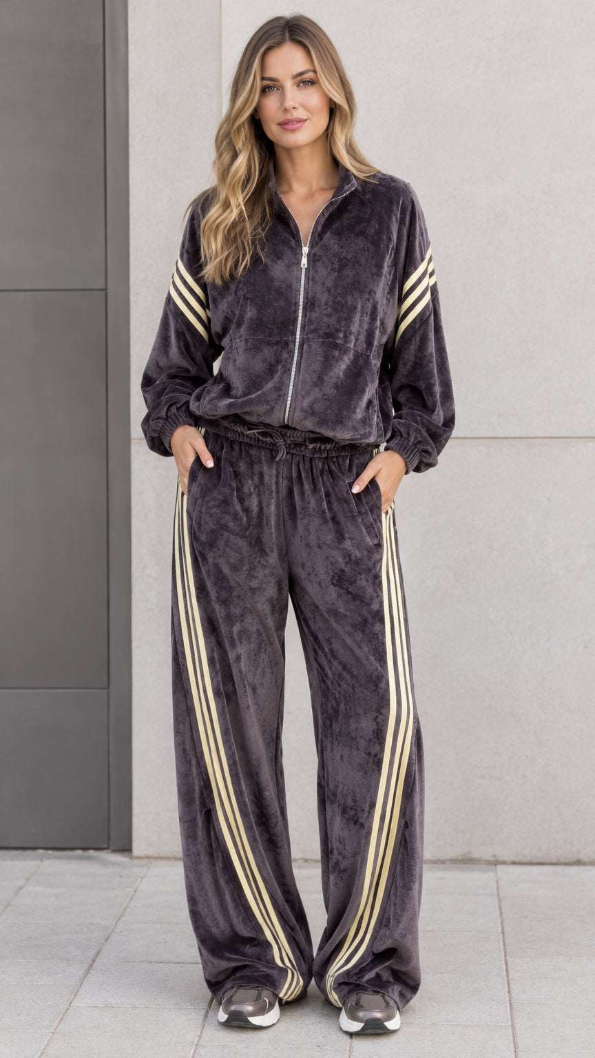 Full front view of model wearing charcoal grey velour tracksuit set with zip jacket and striped wide leg pants