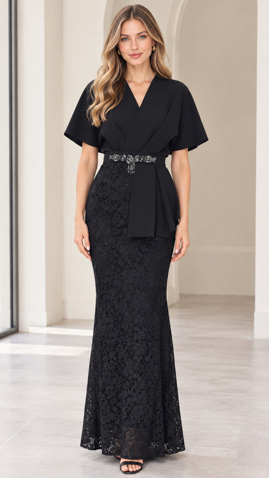 Front full-length view of model wearing black flutter sleeve lace evening maxi dress