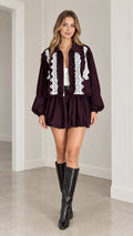 Model wearing Burgundy lace trim zip jacket and bubble shorts matching set front view