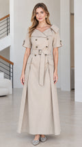 Front view of woman wearing beige double-breasted short-sleeve trench maxi dress with belt