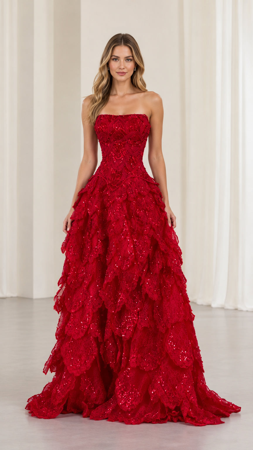 Front view of model wearing red strapless sequin tiered evening ball gown