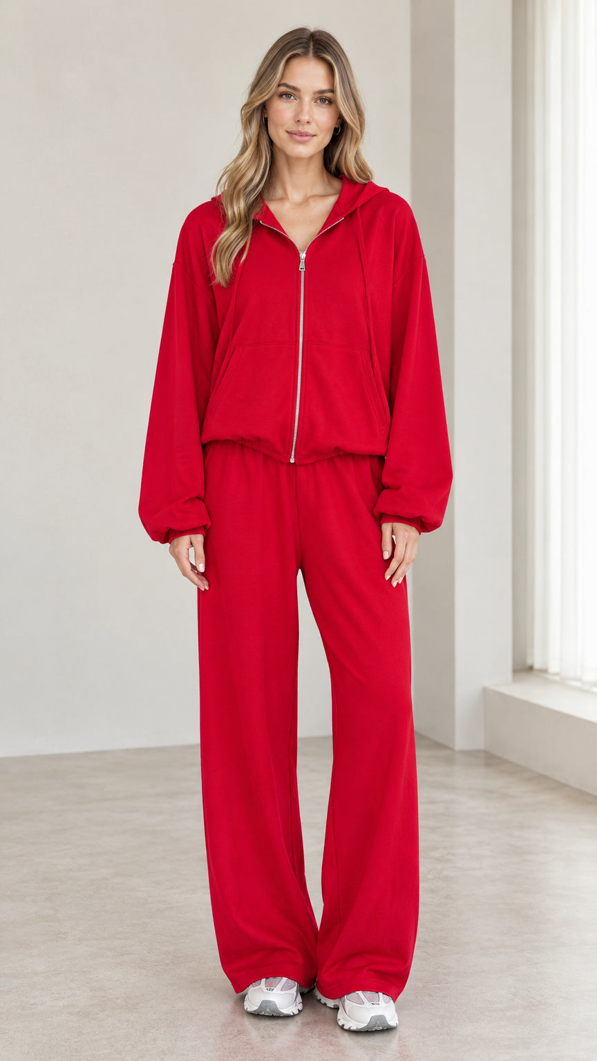 Front view of woman wearing red 2-piece zip-up hoodie and wide-leg pants tracksuit set