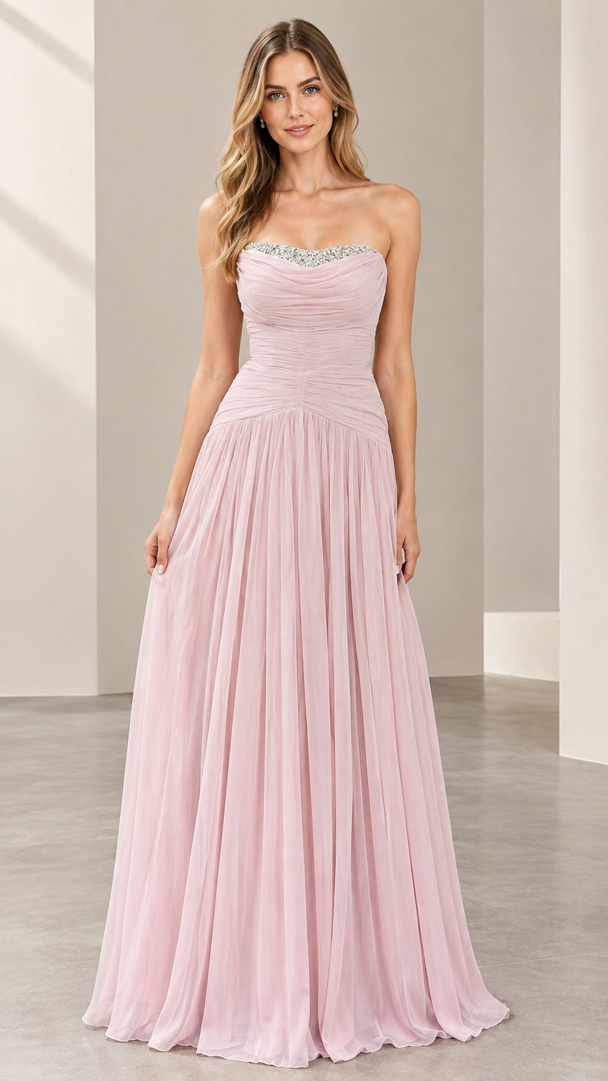 Front full view of woman wearing a strapless blush pink chiffon evening gown with beaded neckline