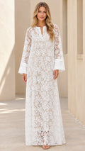 Front view of woman wearing white floral lace split neck maxi dress with wide cuffs