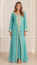 Front view of woman wearing turquoise floral jacquard embroidered layered kaftan dress