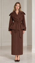 Front view of model wearing chocolate brown belted peplum jacket and maxi skirt set