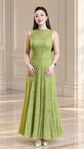 Front view of model wearing light green sleeveless textured plissé A-line maxi dress