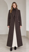 Front view of woman wearing dark brown floor-length double-breasted maxi coat