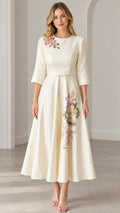 Front view of woman wearing Cream floral embroidered A-line midi dress with 3/4 sleeves