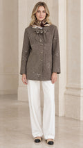 Full front view of model wearing taupe sequin embellished tweed jacket with white trousers