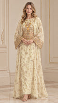 Front full-length view of woman wearing Champagne embroidered kaftan maxi dress with wide bell sleeves