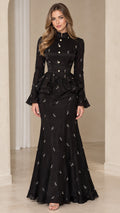Front full-length view of model wearing black embellished peplum mermaid maxi dress
