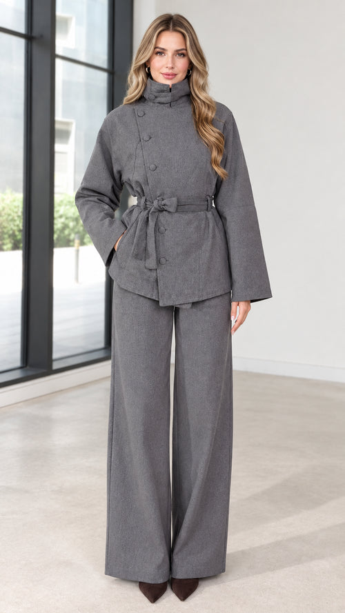 Front full view of women's grey asymmetrical high-neck belted jacket and wide-leg pants set