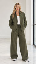 Front full view of woman wearing olive green 2-piece zip jacket and wide leg pants set