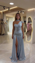 Front full view of woman wearing Ice Blue one-shoulder corset evening gown with high slit