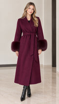 Full front view of model wearing burgundy maxi wrap coat with faux fur cuffs and tie belt