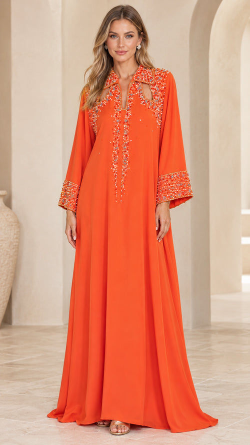 Full-length front view of woman wearing orange beaded cutout kaftan maxi dress