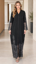 Front full-length view of woman wearing black lace trim abaya maxi dress