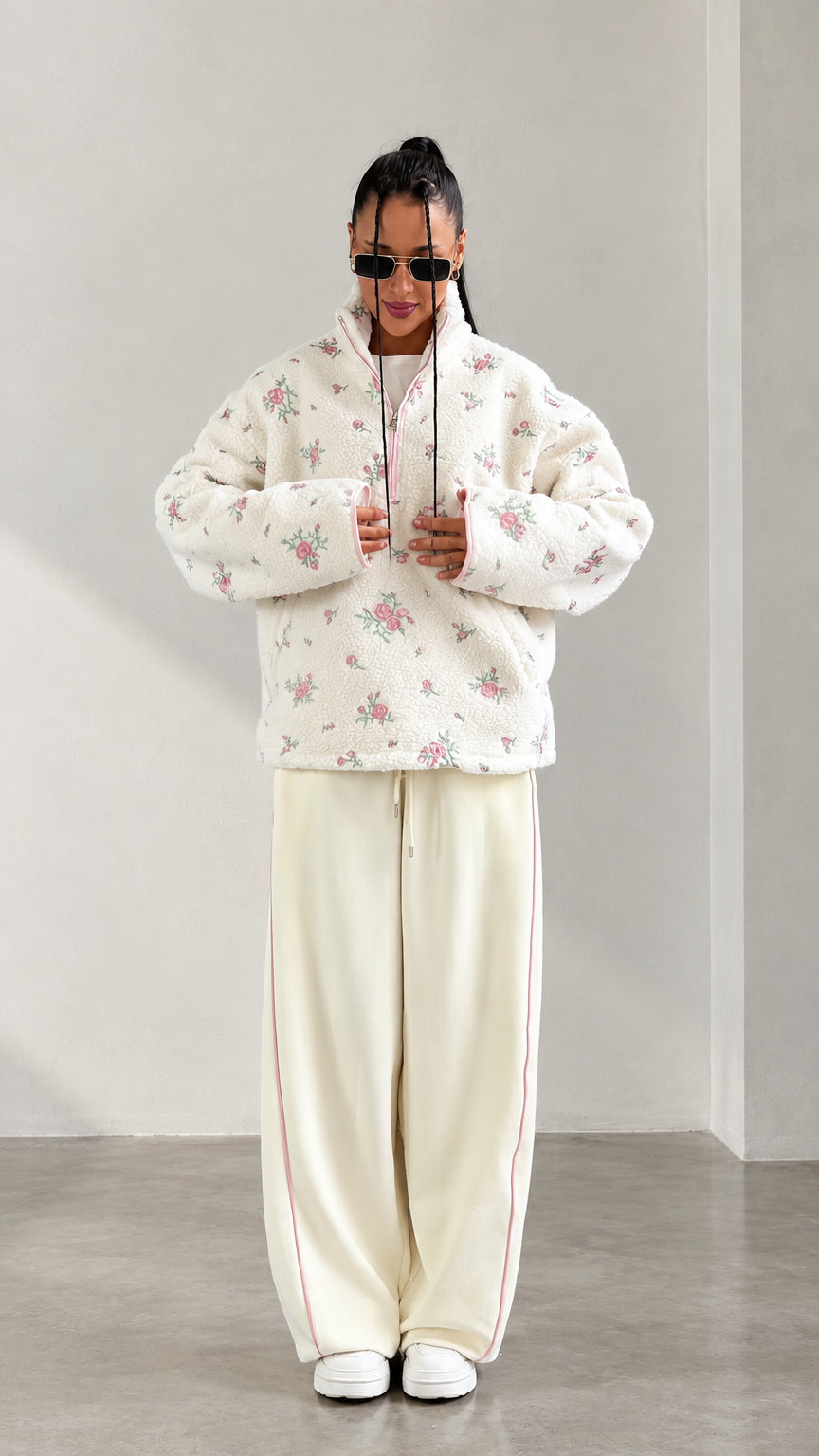 Front view of model wearing cream floral print half-zip sherpa fleece pullover