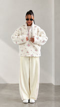 Front view of model wearing cream floral print half-zip sherpa fleece pullover