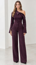 Front view of model wearing plum asymmetric off-the-shoulder wide-leg jumpsuit