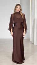 Front view of model wearing Chocolate Brown mock neck sheer capelet maxi dress