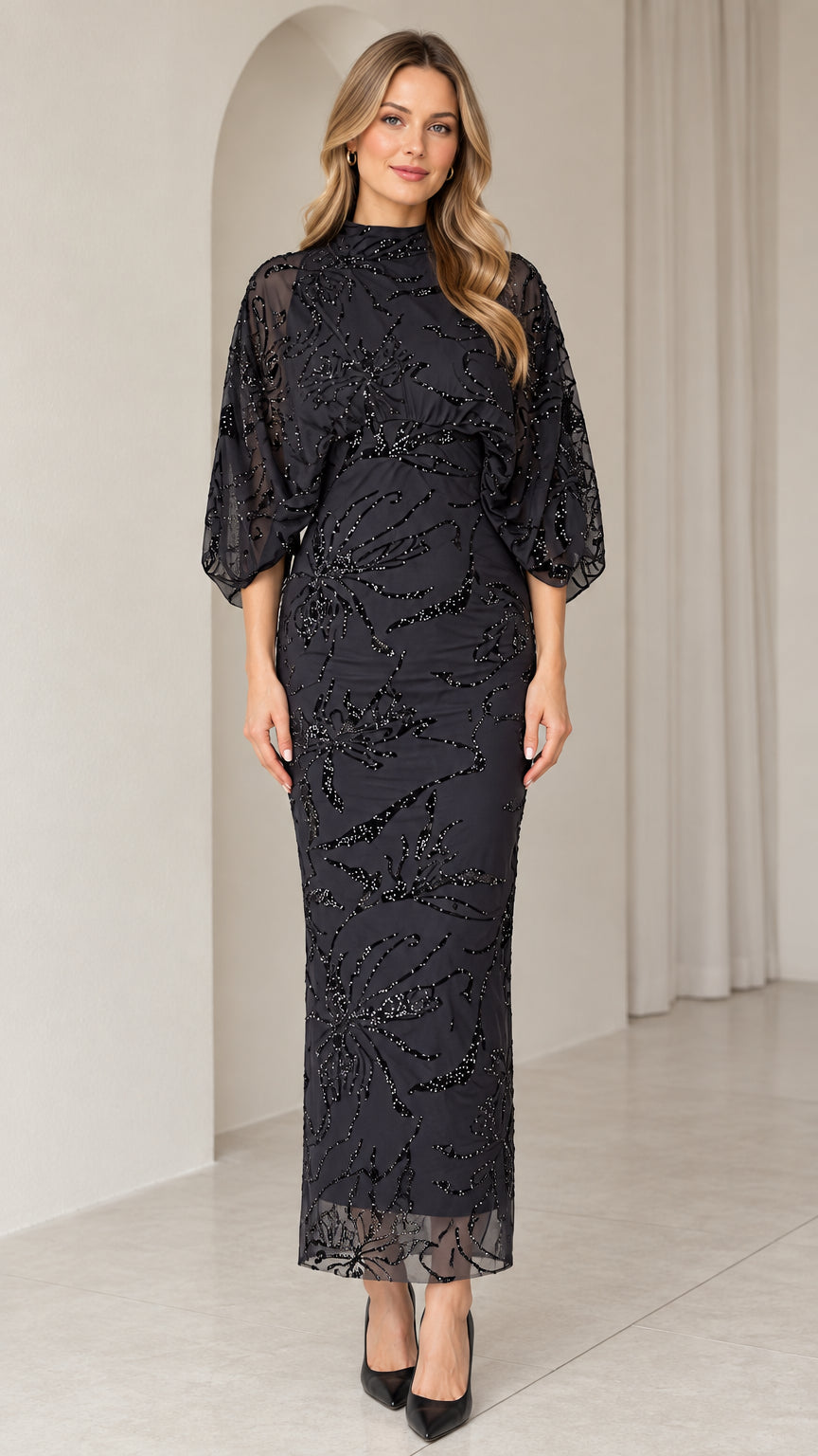 Front view of black mock neck beaded column evening dress with sheer dolman sleeves