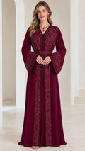 Front view of woman wearing burgundy embroidered beaded kaftan maxi dress with belt