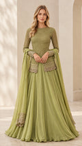 Front full view of woman wearing sage green embroidered long sleeve peplum top with pleated maxi skirt and dupatta