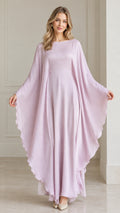 Front view of woman wearing flowing lavender draped cape sleeve kaftan maxi dress