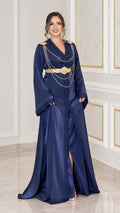 Full front view of navy blue satin kaftan maxi dress with gold shoulder chains and belt