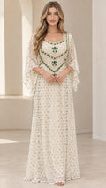 Front full-length view of woman wearing ivory embellished kaftan maxi dress with flutter sleeves