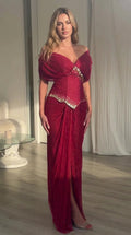 Full front view of model wearing burgundy off-the-shoulder embellished basque waist maxi dress