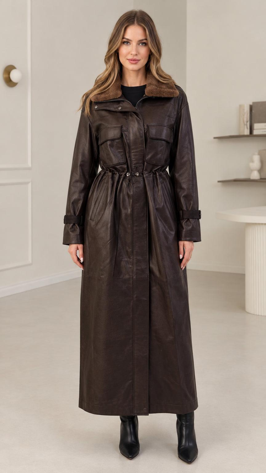 Front view of model wearing dark brown faux leather maxi trench coat with plush collar