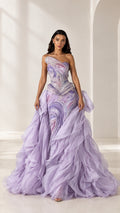 Front full-length view of model wearing lavender one-shoulder embellished ruffle formal gown