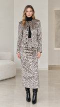 Full front view of model wearing Taupe Grey leopard print jacket and maxi skirt two-piece set with black boots
