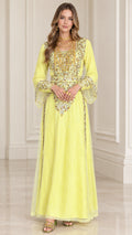 Front full-length view of woman wearing yellow embroidered kaftan maxi dress