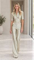 Front view of model wearing champagne gold metallic shimmer belted short sleeve jumpsuit