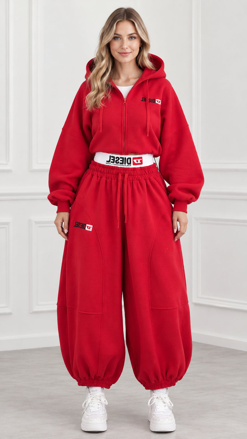 Front view of model wearing red cropped zip hoodie and balloon sweatpants set
