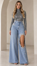 Full front view of model wearing Light Blue Rhinestone Cutout Wide Leg Jeans and Silver Shimmer Mock Neck Top