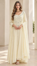 Front full view of woman wearing ivory embroidered chiffon maxi dress with cape sleeves