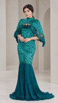 Front view of model wearing Teal Green embroidered cape mermaid gown with tassel trim