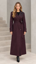 Front full-length view of woman wearing burgundy maxi trench coat with tie belt