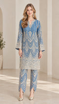 Full front view of model wearing royal blue embroidered tunic top and matching tulip hem pants