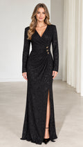 Front full-length view of woman in black long sleeve jacquard maxi dress with ruched waist and slit