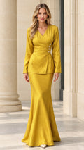 Front view of woman wearing mustard yellow jacquard wrap top and mermaid maxi skirt set